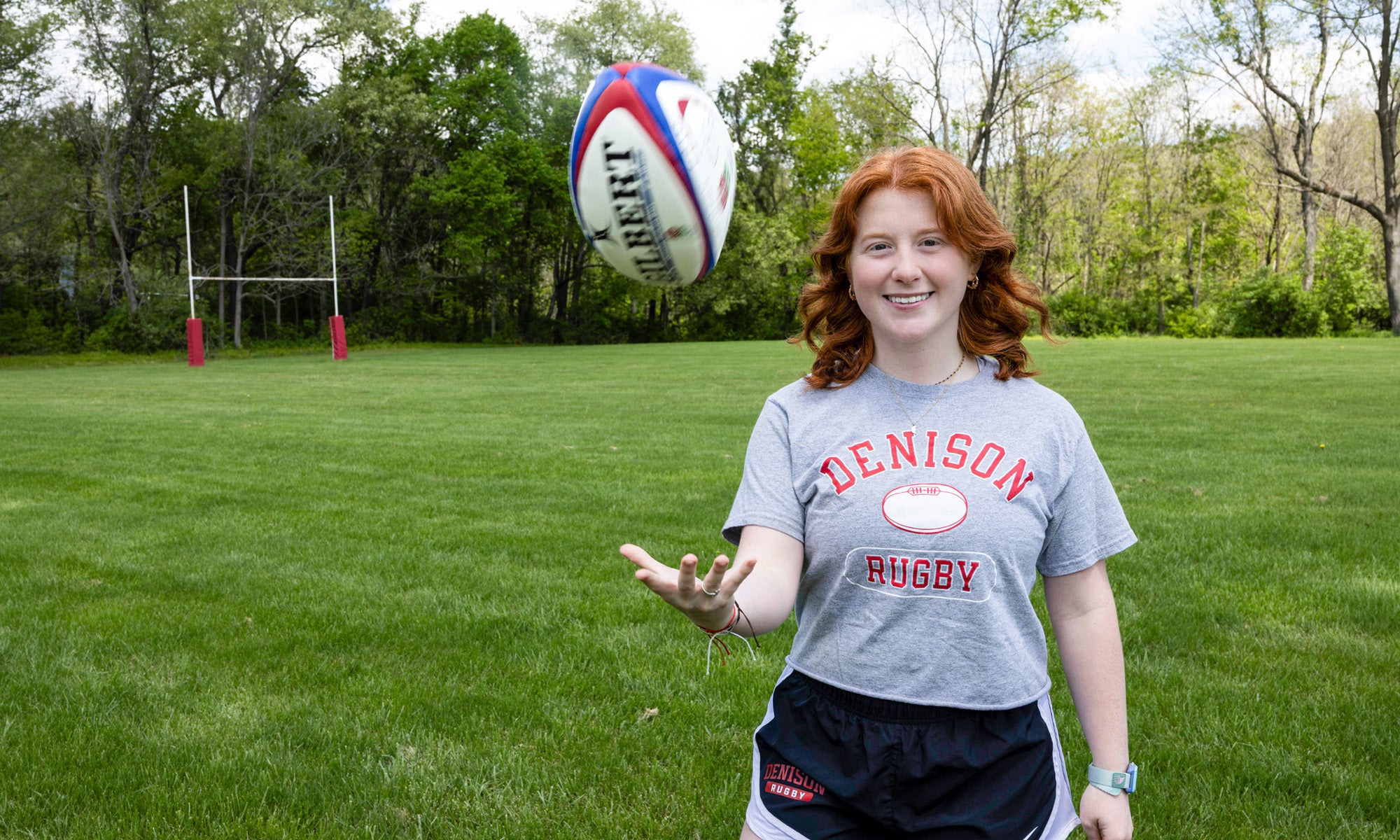 Abby Crady tossing a rugby ball