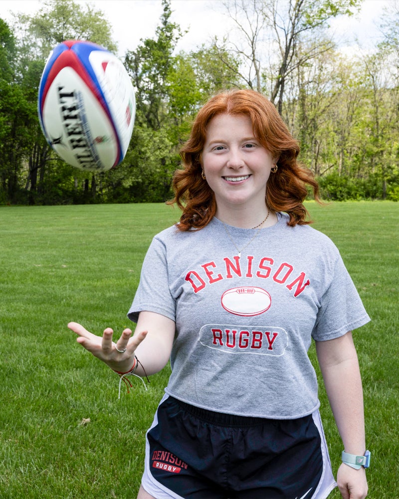 Abby Crady tossing a rugby ball