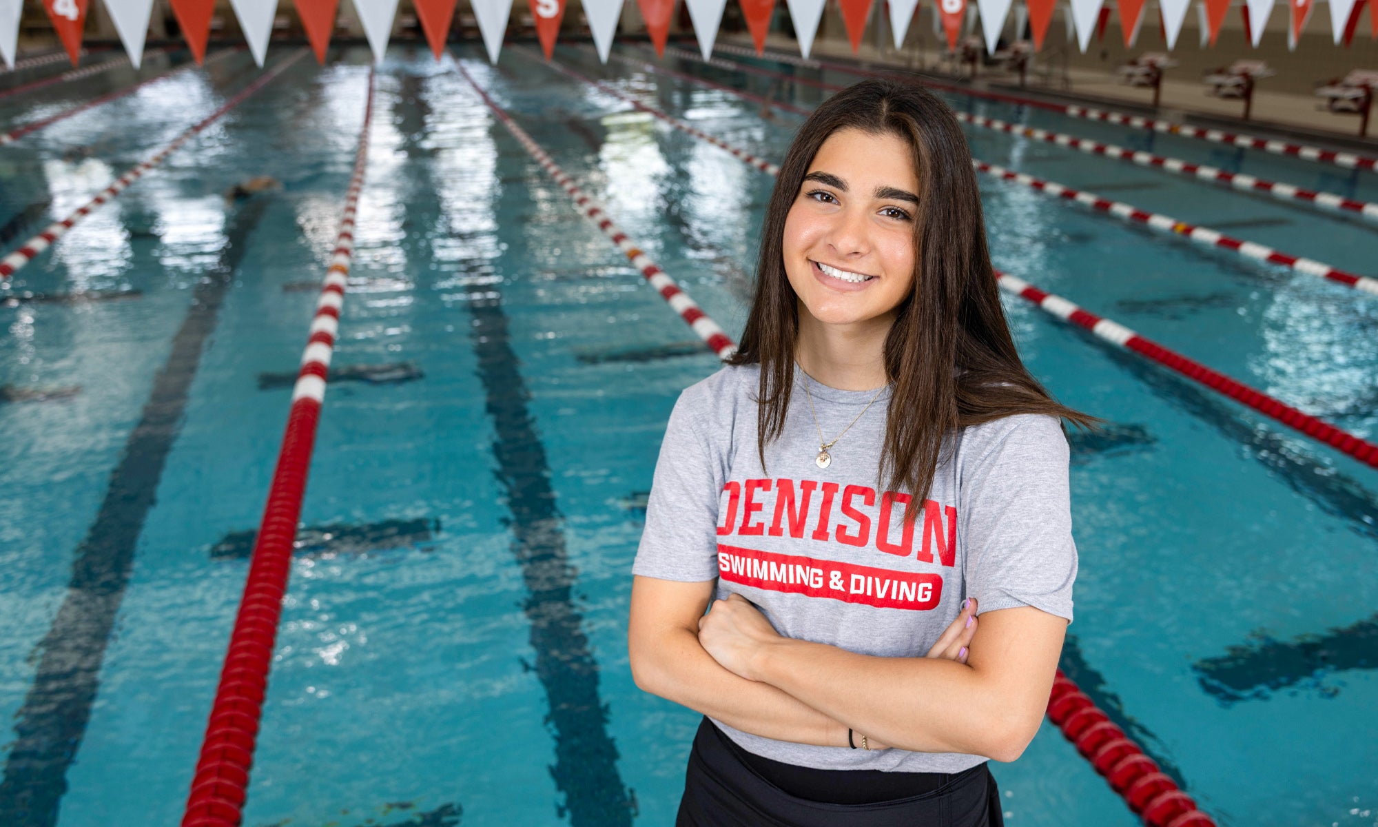 Audrey Brink standing in front of a pool