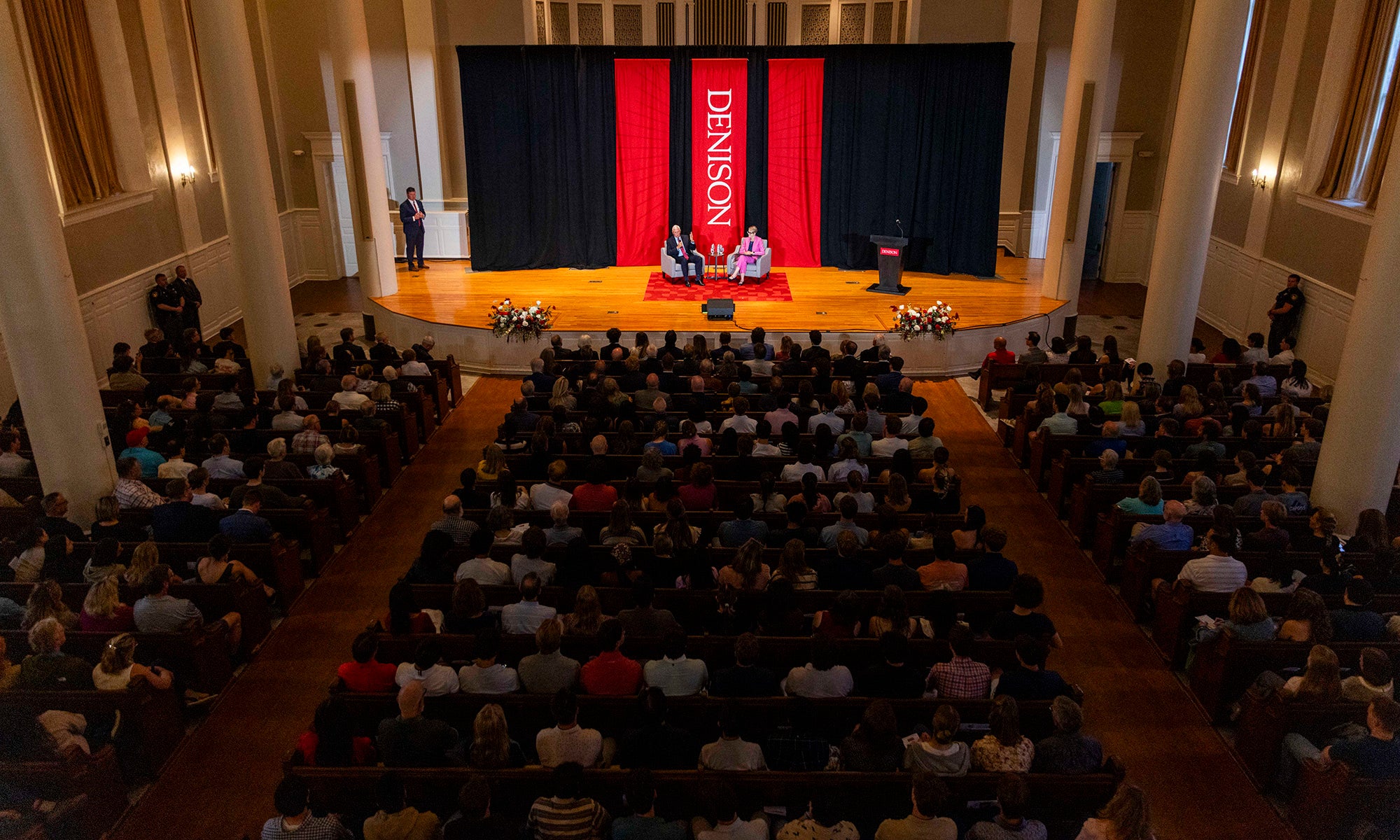 Overhead view of Swasey Chapel filled with an audience listening to a moderated discussion on stage.
