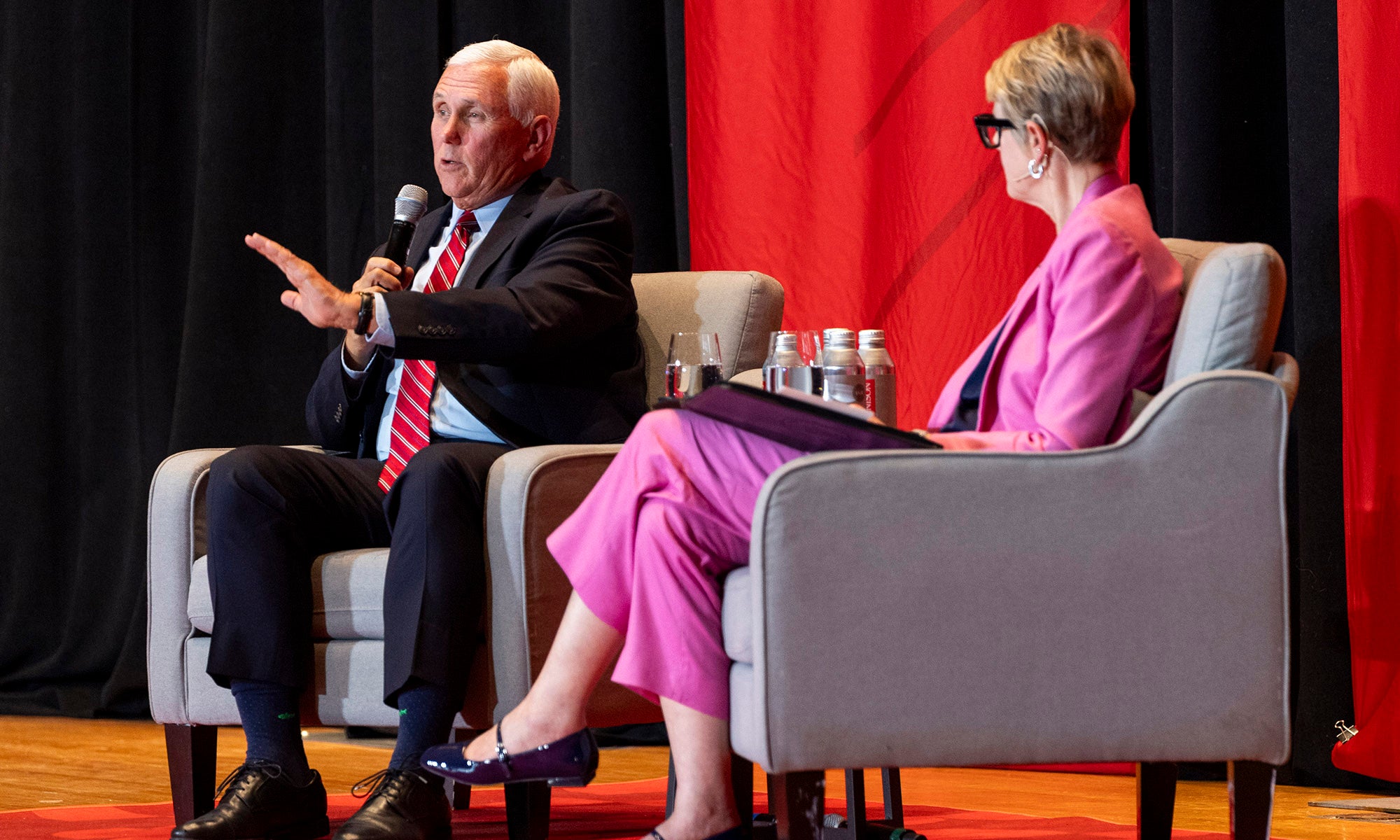 Vice President Mike Pence seated on stage in a moderated discussion with a member of the Denison faculty..