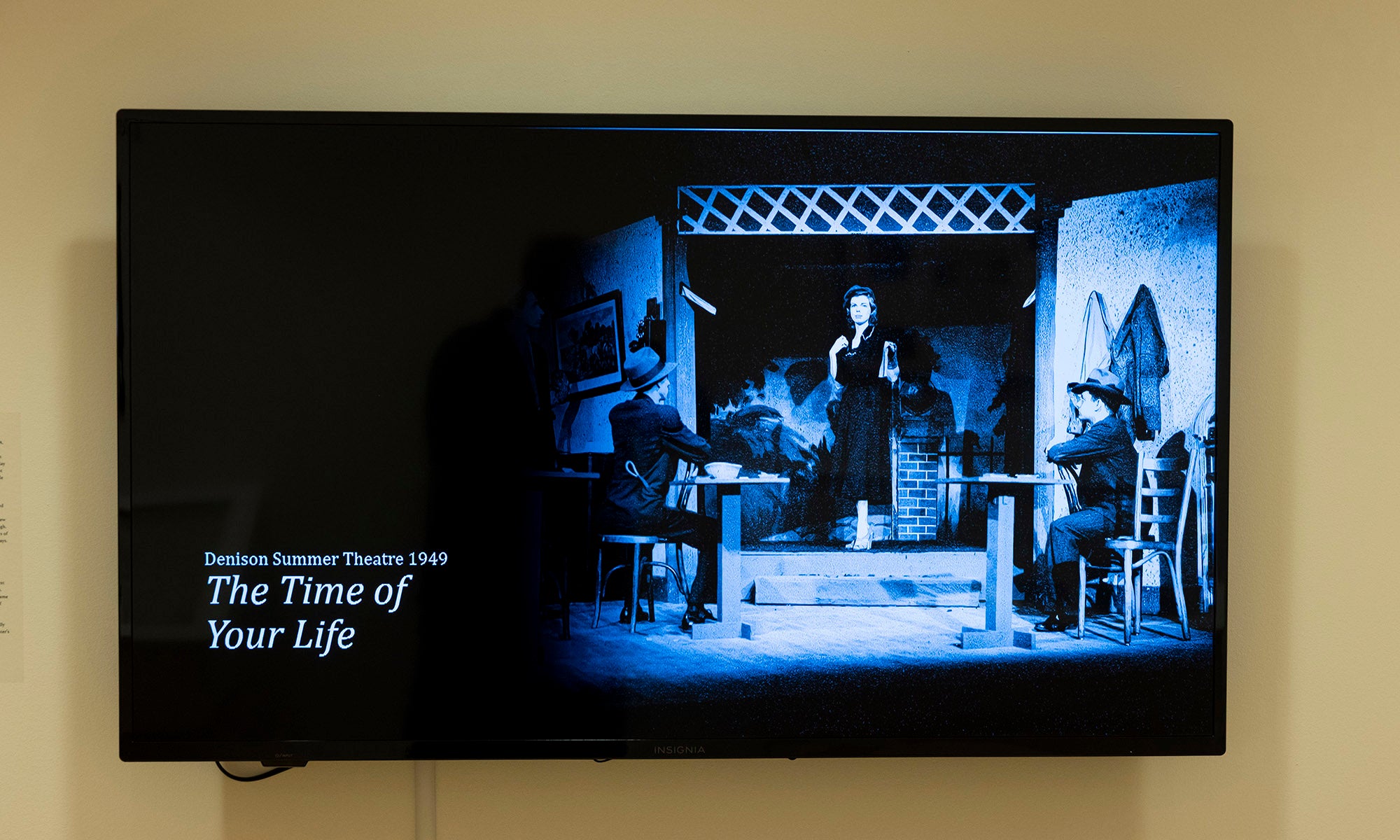 A television screen displays a black-and-white scene from a stage play, with three actors in period costumes. Text on the left reads: “Western Summer Theatre 1968 The Time of Your Life.” A nod to Broadway graces this Denison Museum exhibit.