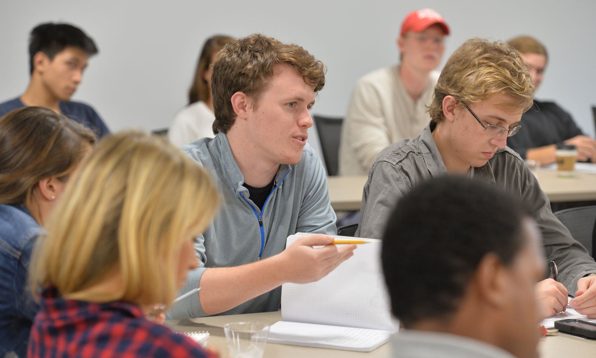 Conference attendees in a college meeting room.