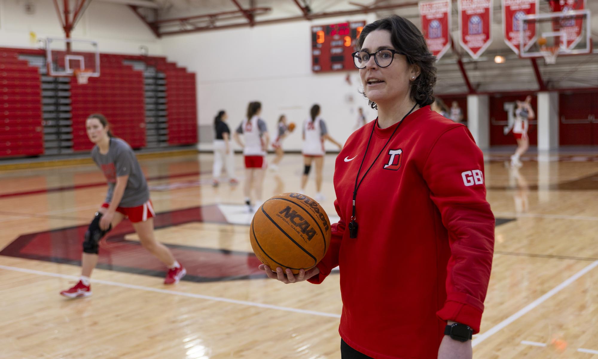 Coach Maureen Hirt on the sidelines during practice, coaching her players.