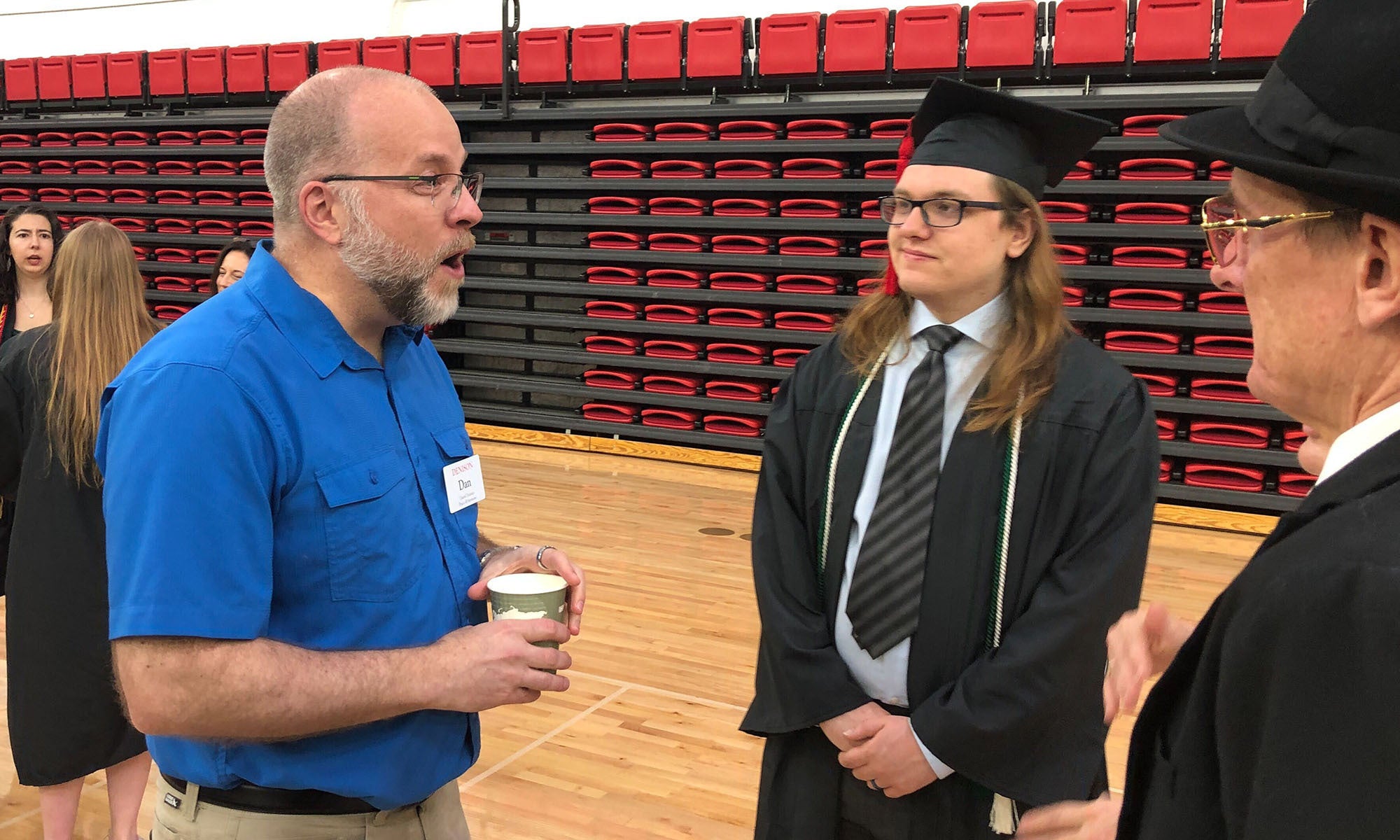 Professor Dan Homan speaks with a senior before Denison Commencement begins.