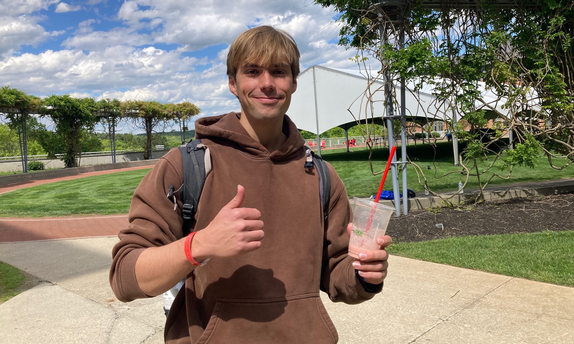 Student Grant Hunter sips a smoothie on Denison's campus.