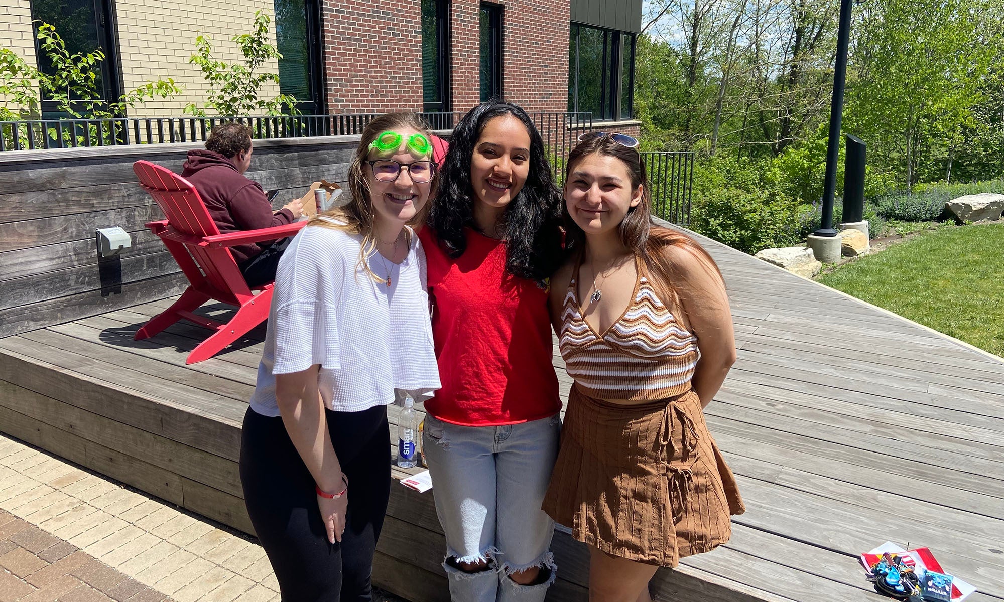 Three students pose for a photo outside of Silverstein Hall