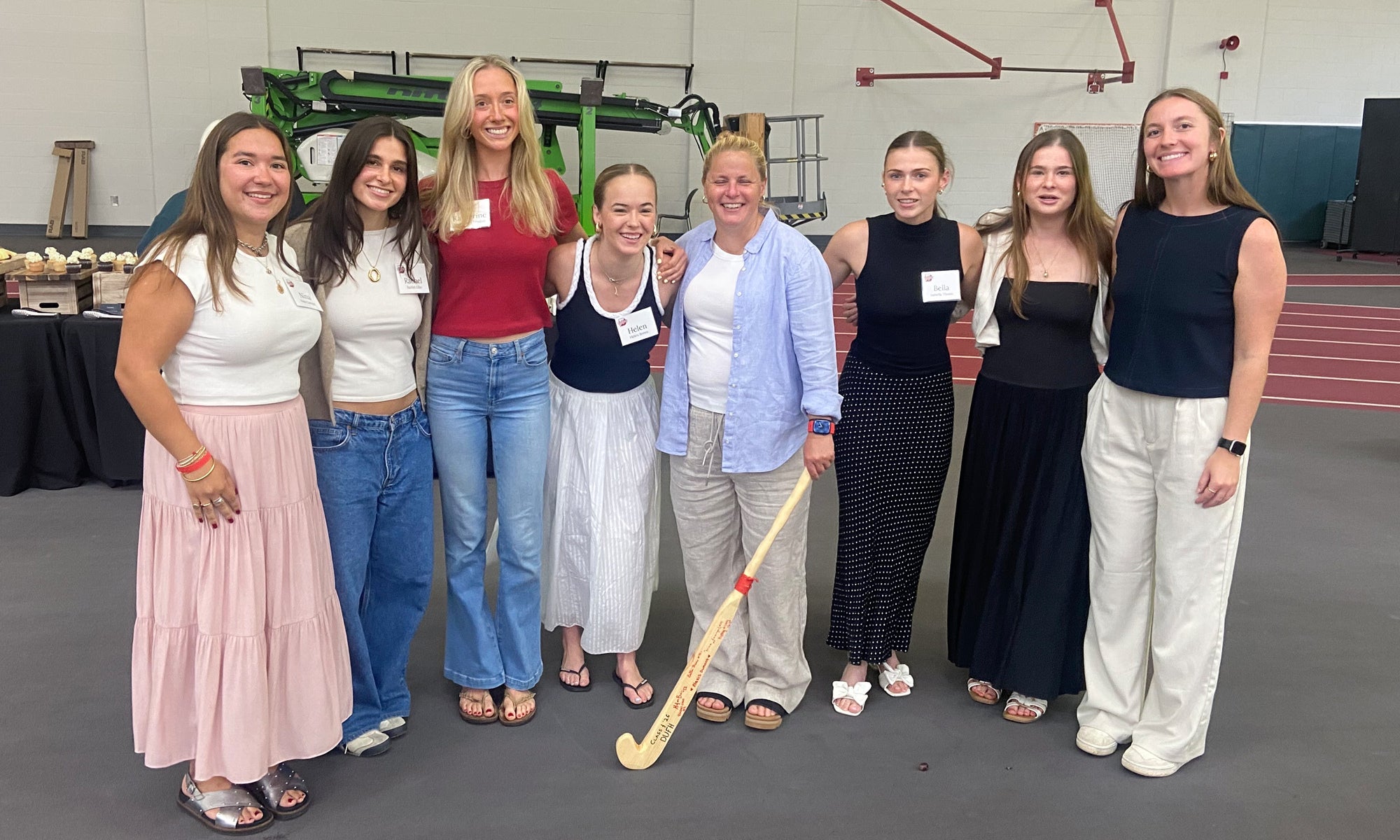 women with field hockey sticks