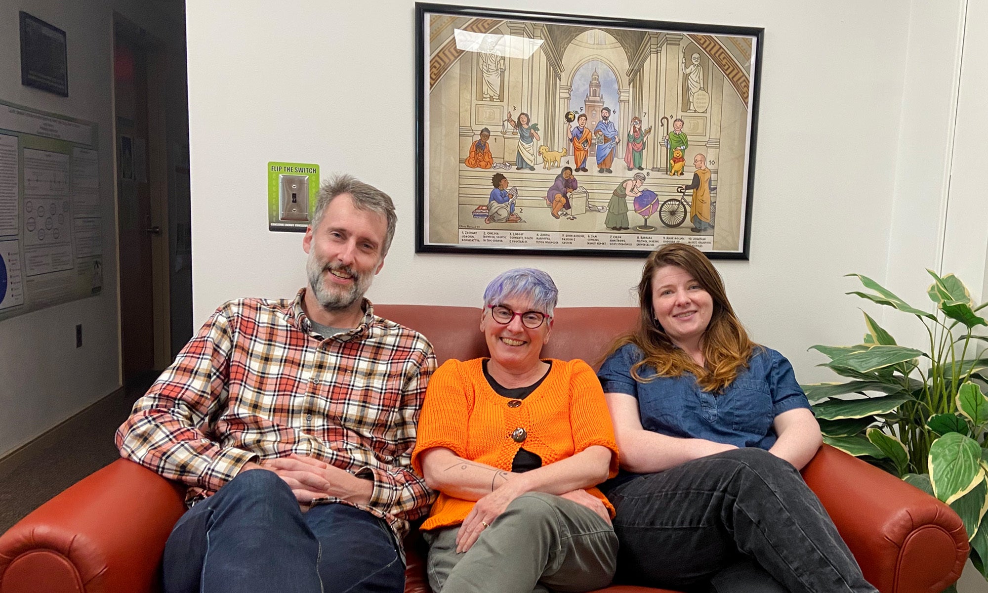 Philosophy faculty at Denison sit beneath a gift from a former student, depicting the department faculty.