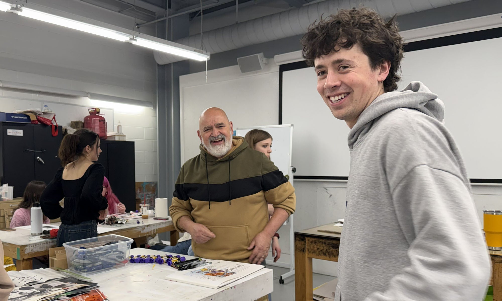 A professor and student working on an art project.