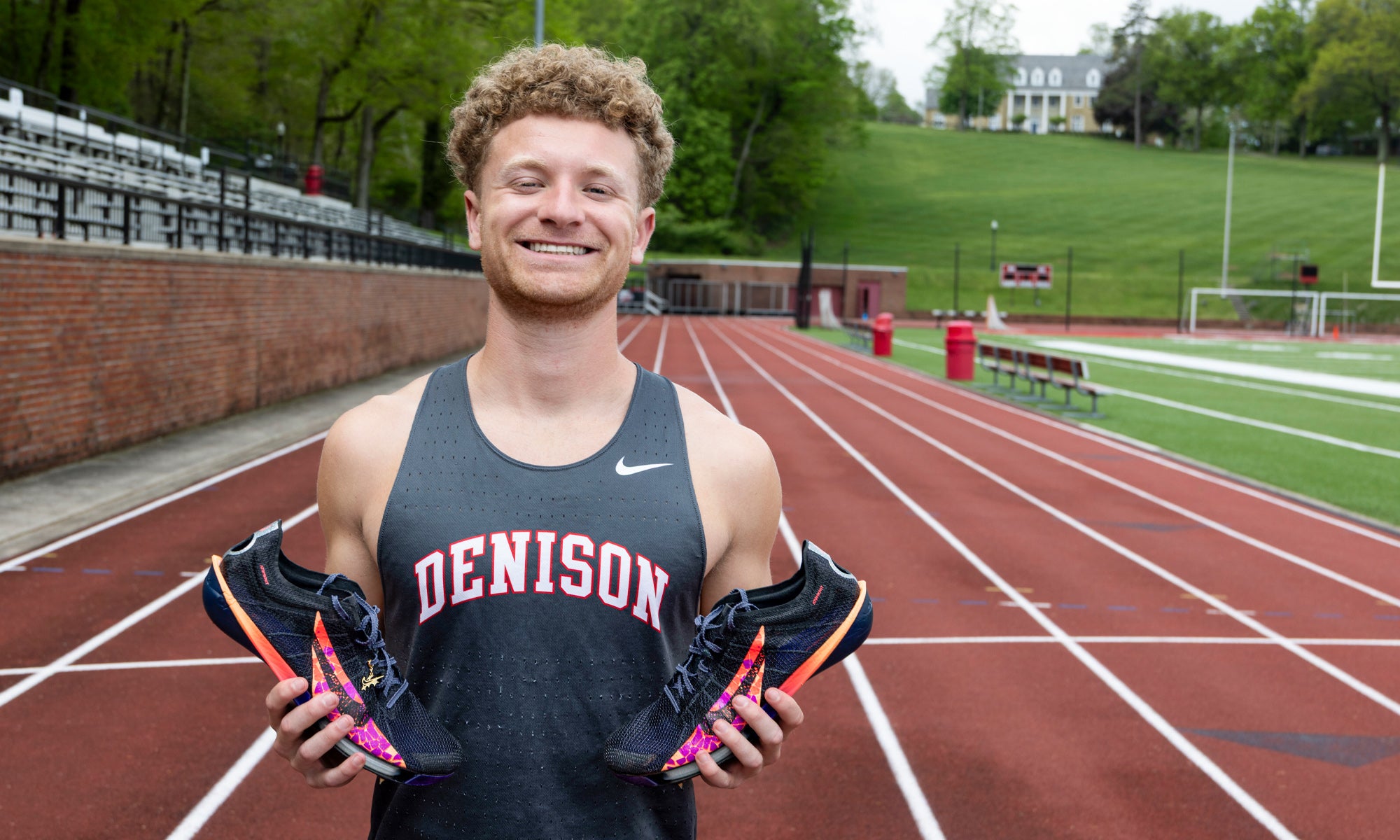Jacob Brechbill poses with his running shoes