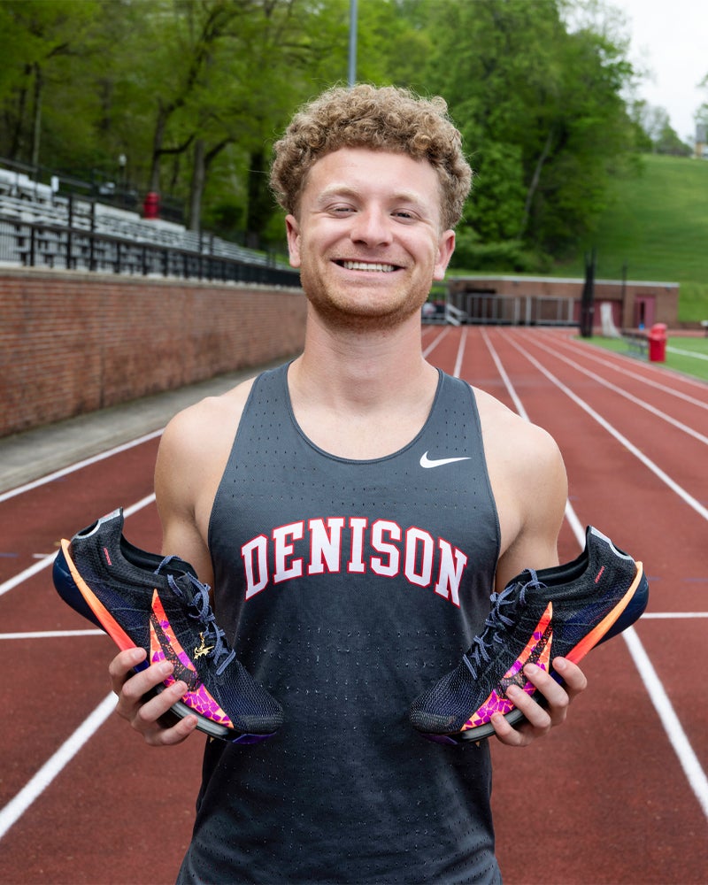 Jacob Brechbill poses with his running shoes
