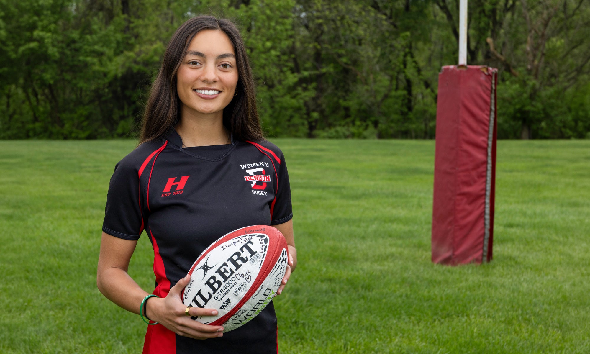 Josie Hansen holding a rugby ball