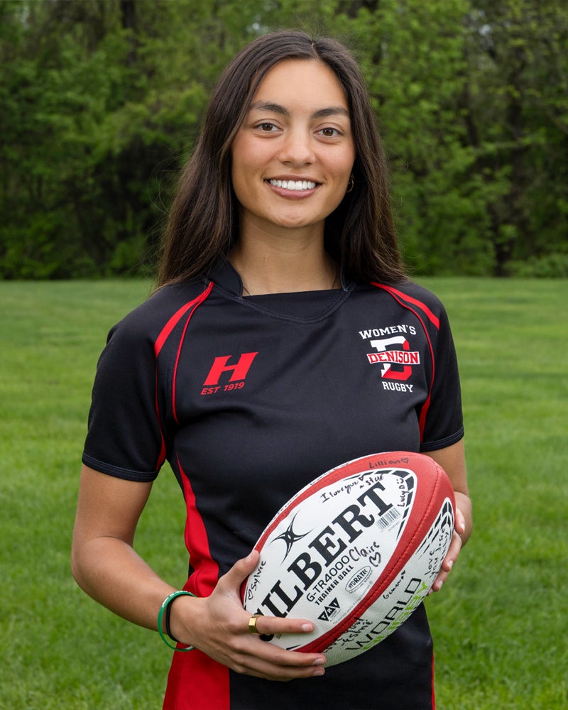 Josie Hansen holding a rugby ball