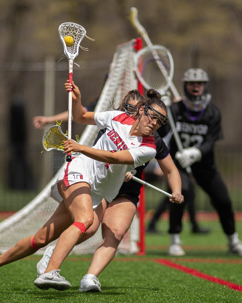 Lacrosse players playing a game on the field.