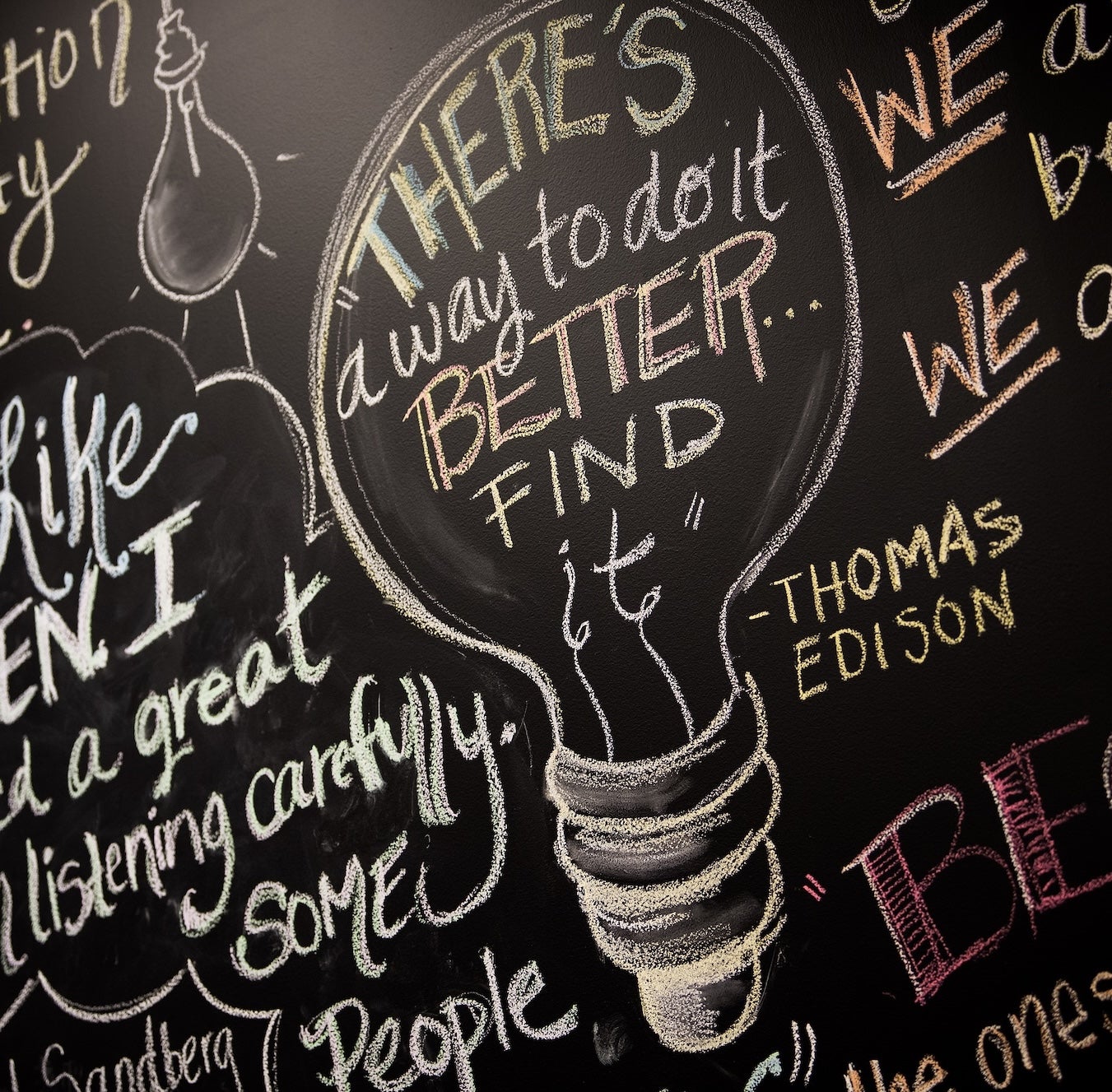 Inspirational drawings and sayings written on a chalkboard
