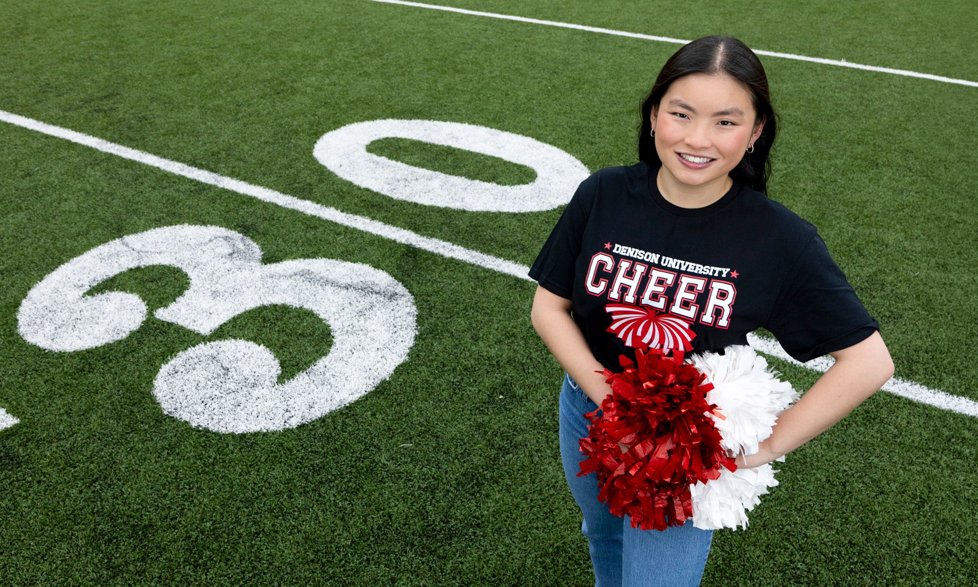 Marin Tanner on a football field with pompoms