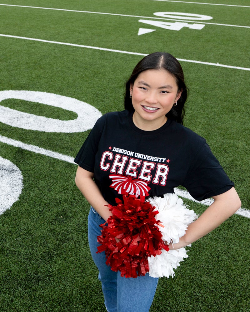 Marin Tanner on a football field with pompoms