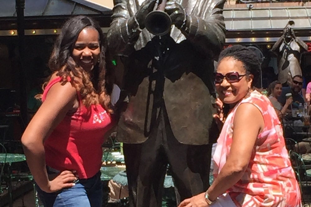 Christina Millender '99 and Dr. Betty Lovelace pose in front of a statueLovelace