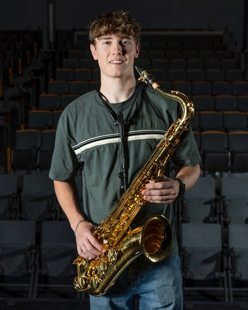 Nathan Wilson holding a saxophone