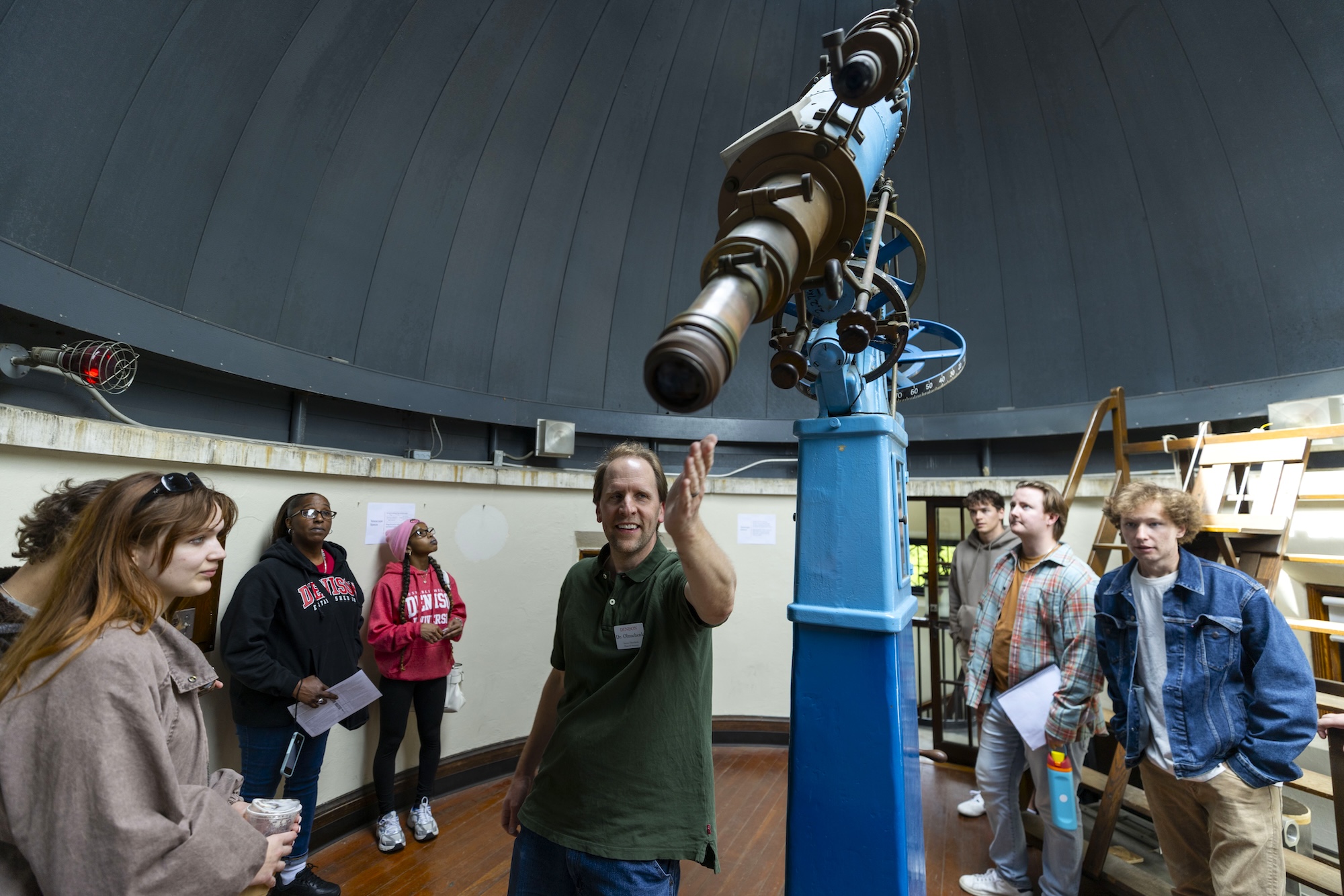 Group of people looking at the large telescope at Swasey Observatory