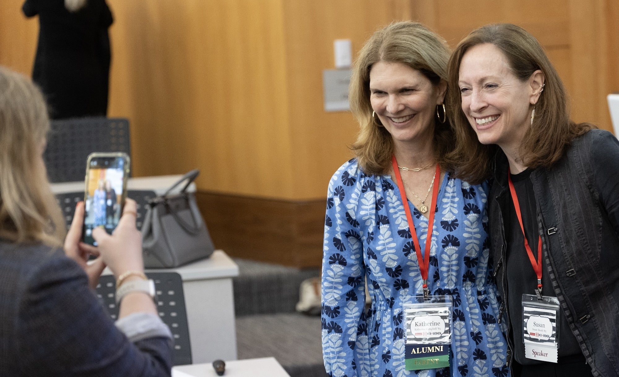 Susan Booth '85 poses with an alum at a [RE]MIX Women event