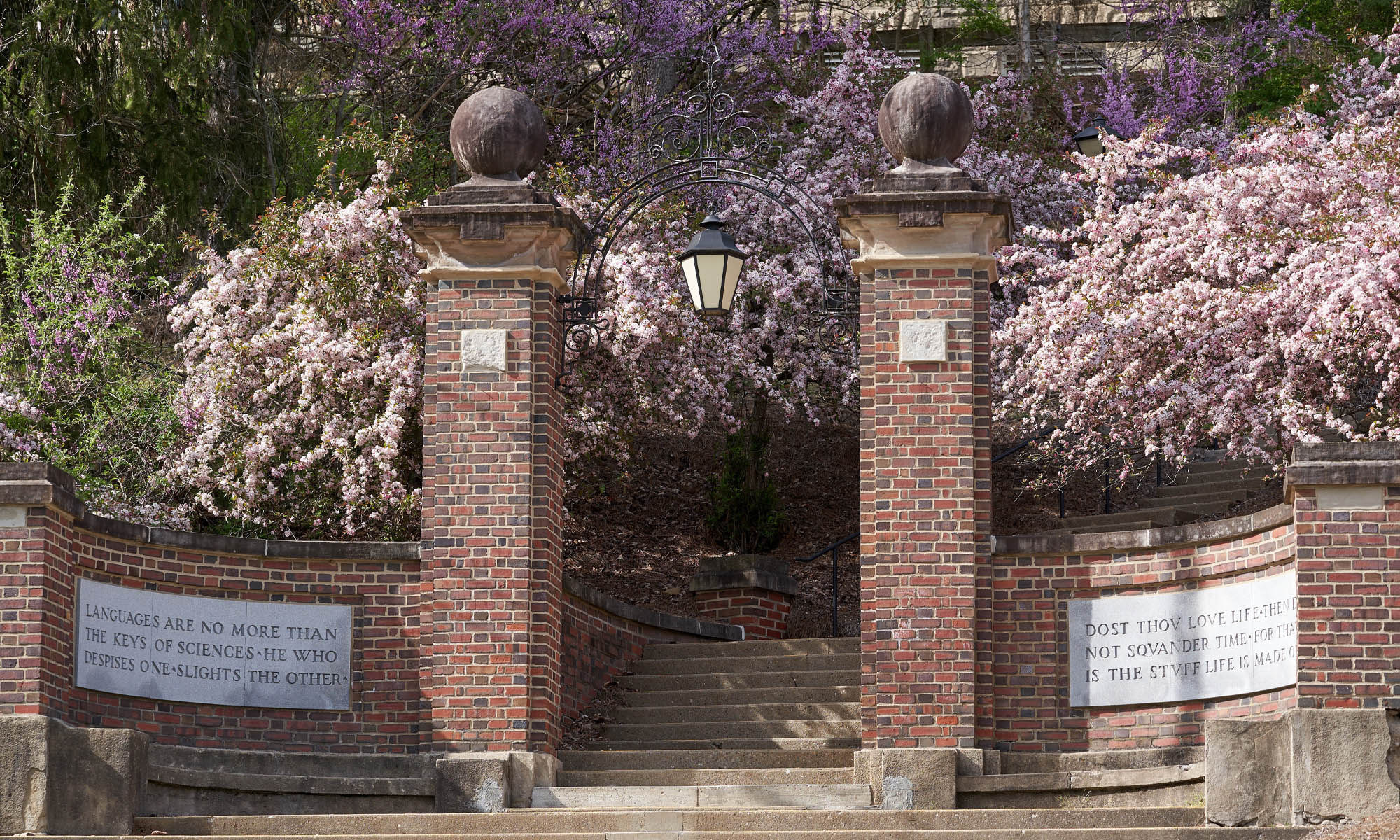 Steps lead up to two brick columns creating an entryway to campus at Burg Street.