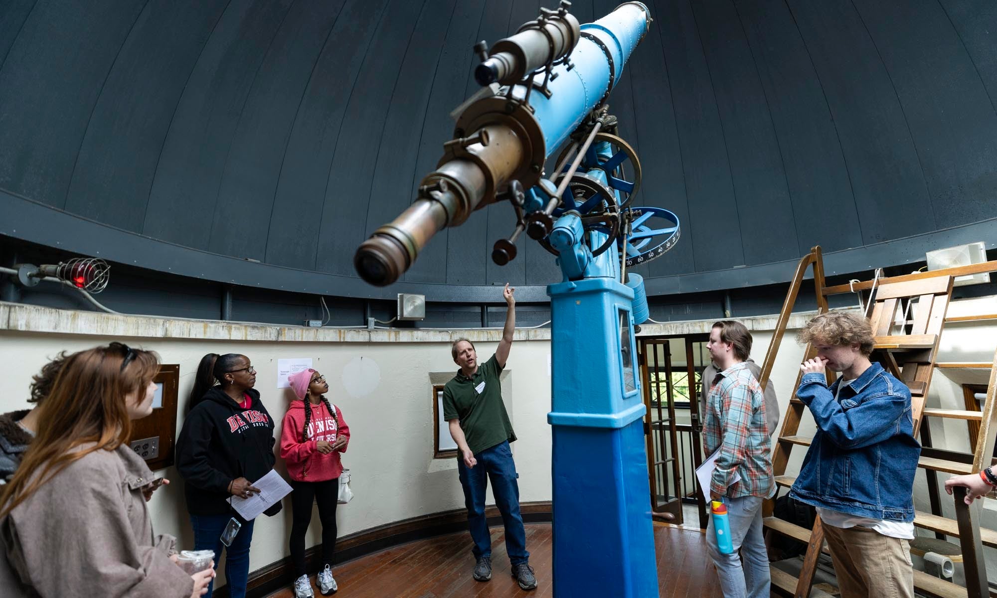 Associate Professor Steven Olmschenk explains the features of the Swasey Observatory to Denison students.