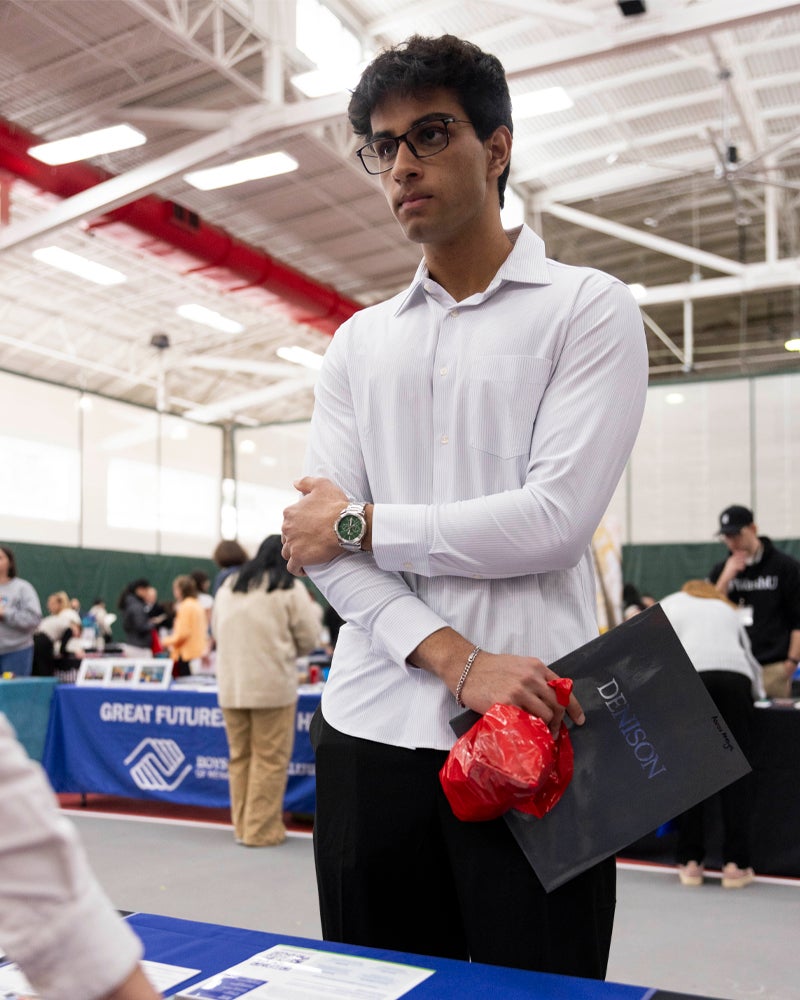 A student talking at a career fair.