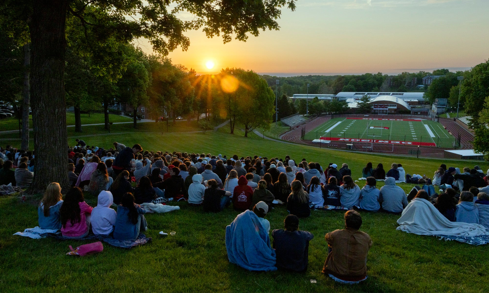 Denison seniors gather to watch the sunrise on their last day as students.