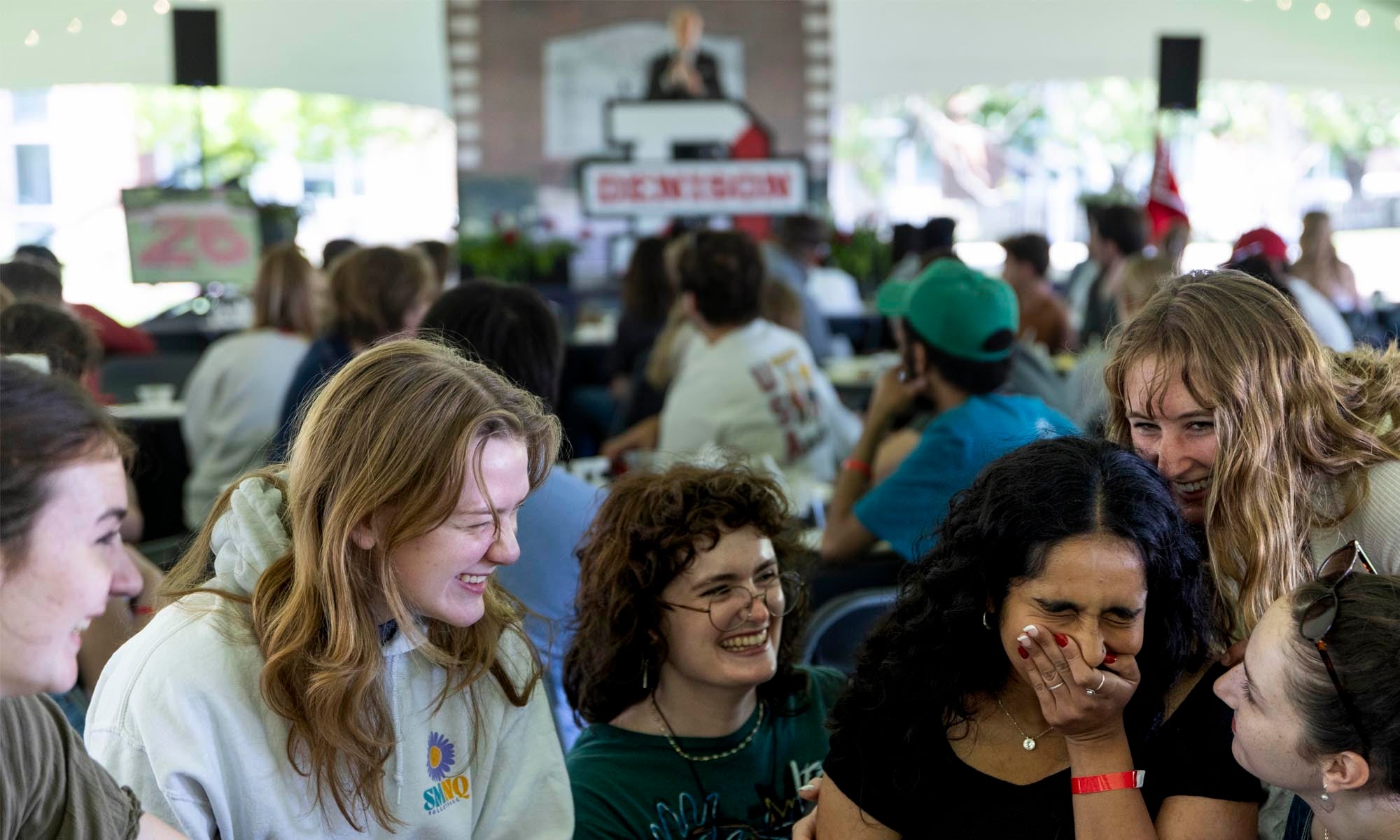 A group of student surround an emotional graduation senior during a class celebration.