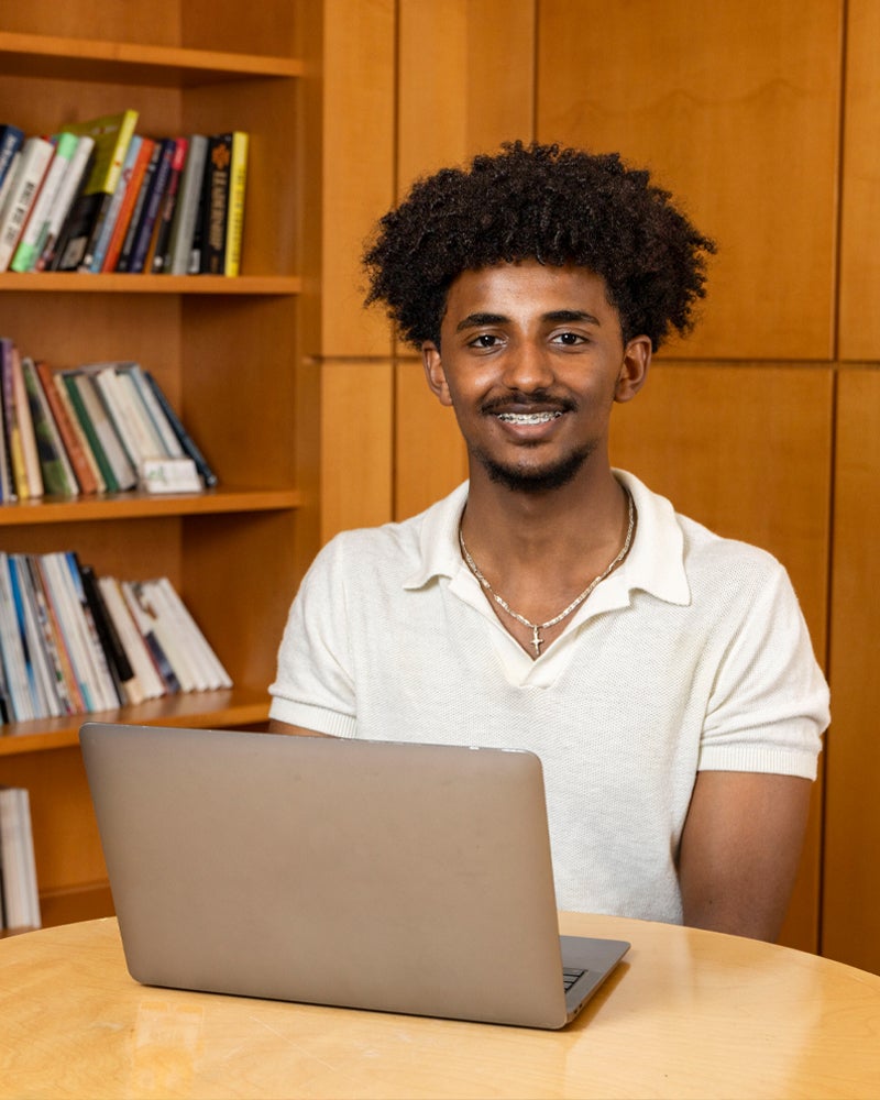 Yohannes Mulualem sitting at a laptop