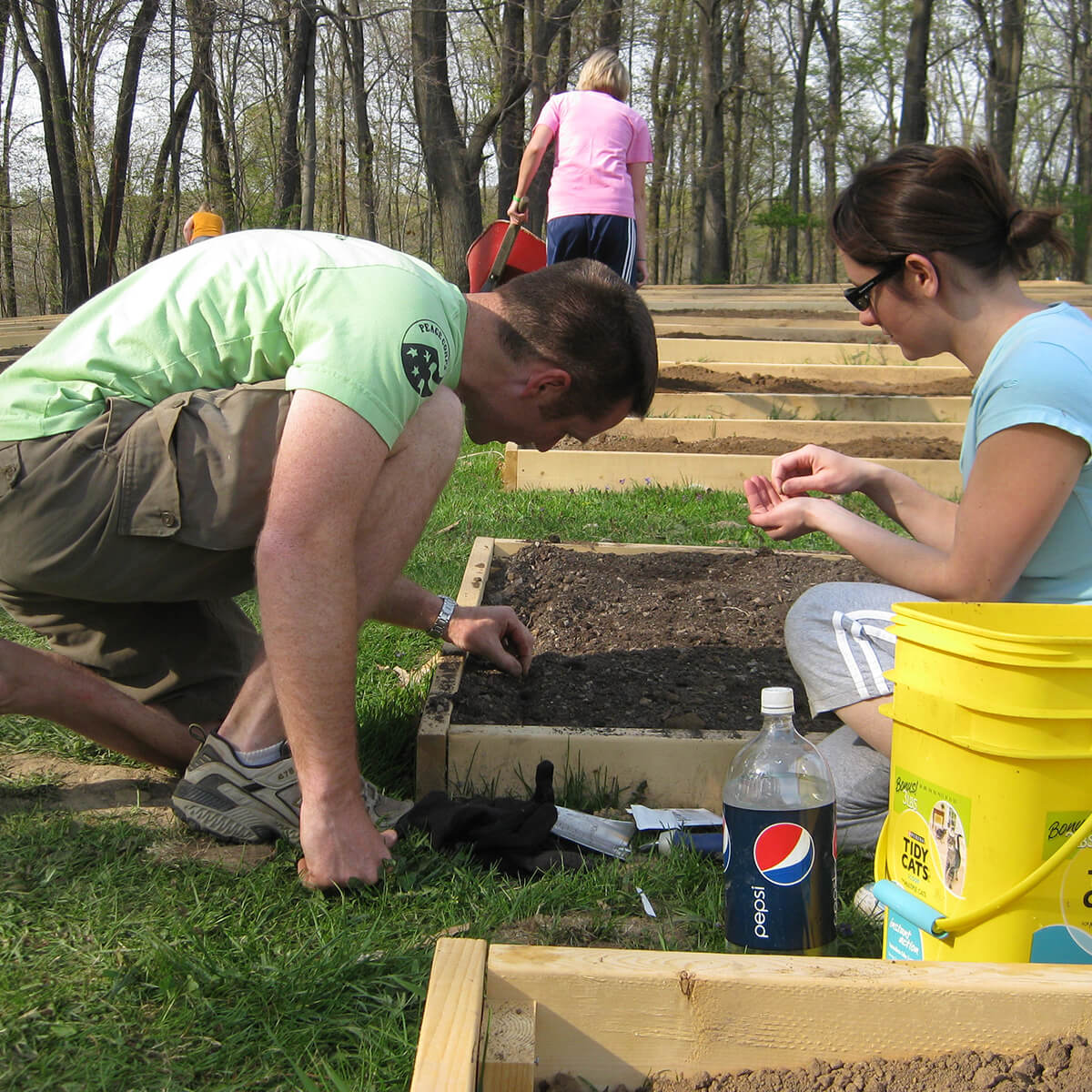 Faculty and staff planting seeds in the Denison Community Garden.