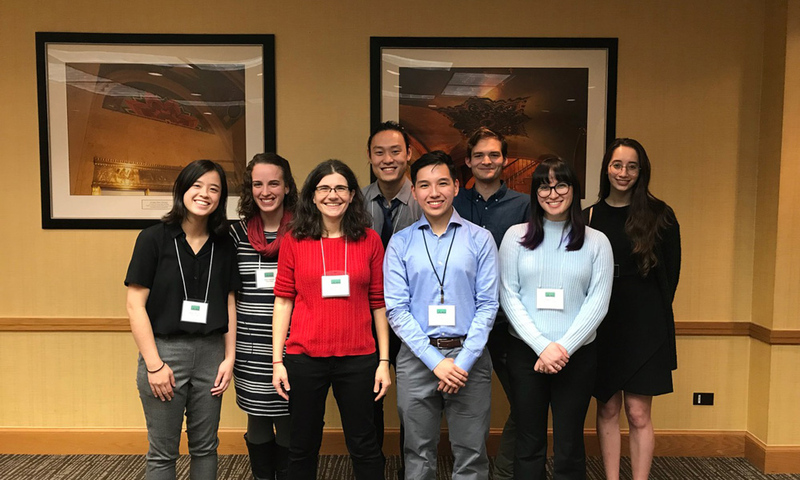 Students and recent alumni at a conference with Associate Professor of Chemistry Rachel Mitton-Fry