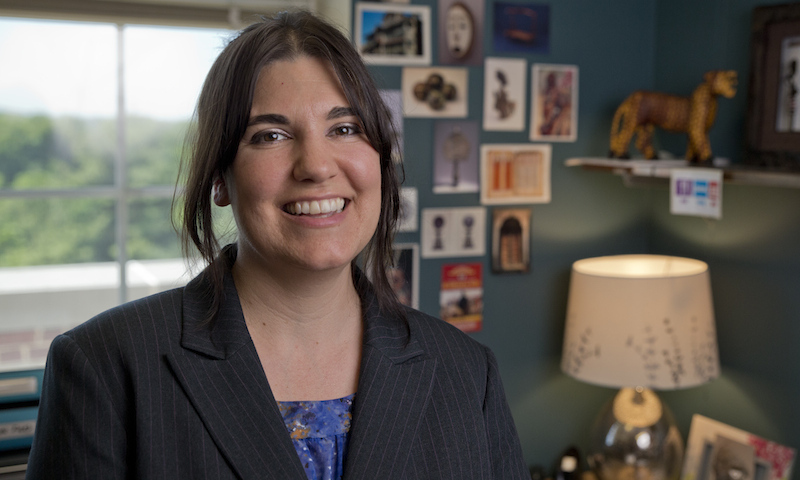 Joanna Tague, smiling in office