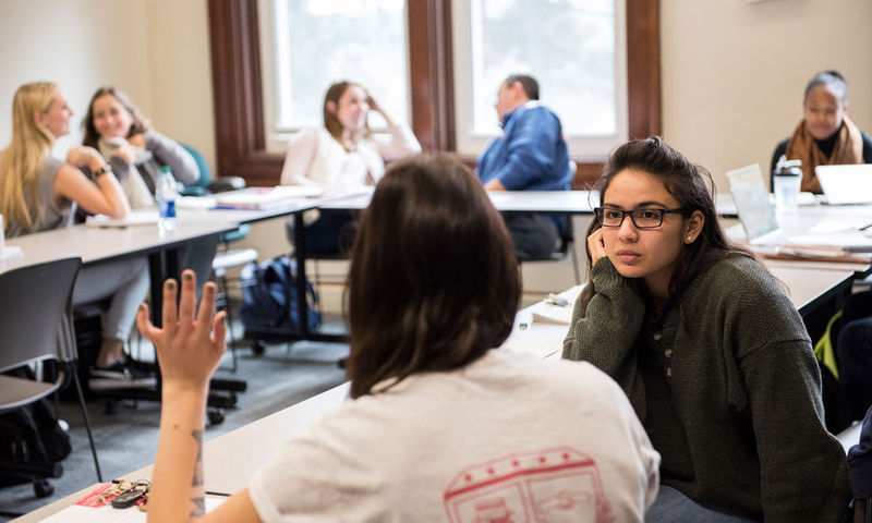 Students in a classroom talking in pairs