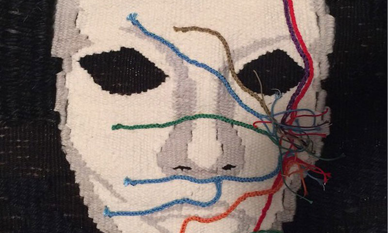 Art piece of a face with colored string spreading across it