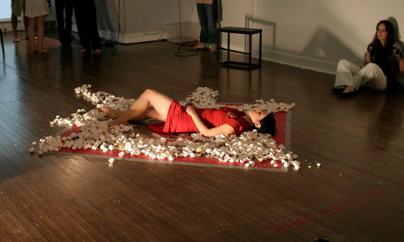 Woman laying on ground in red dress