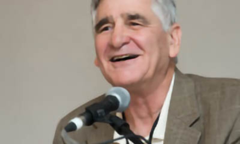 Henry Reichman speaking at a microphone.