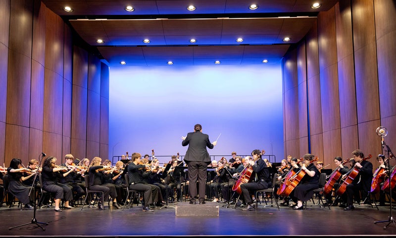 Orchestra and Choir playing instruments