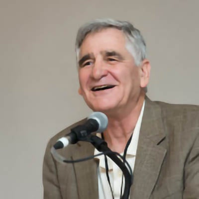 Henry Reichman speaking at a microphone.