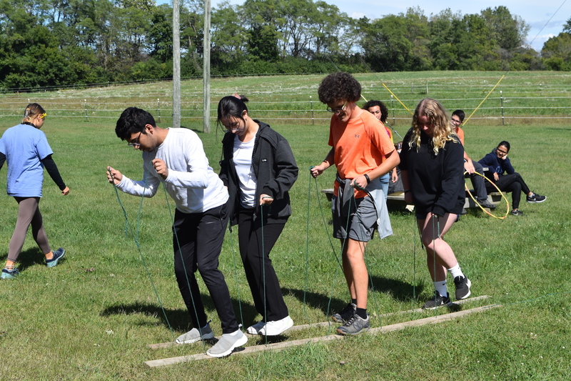Student participating in a team-building exercise outdoors