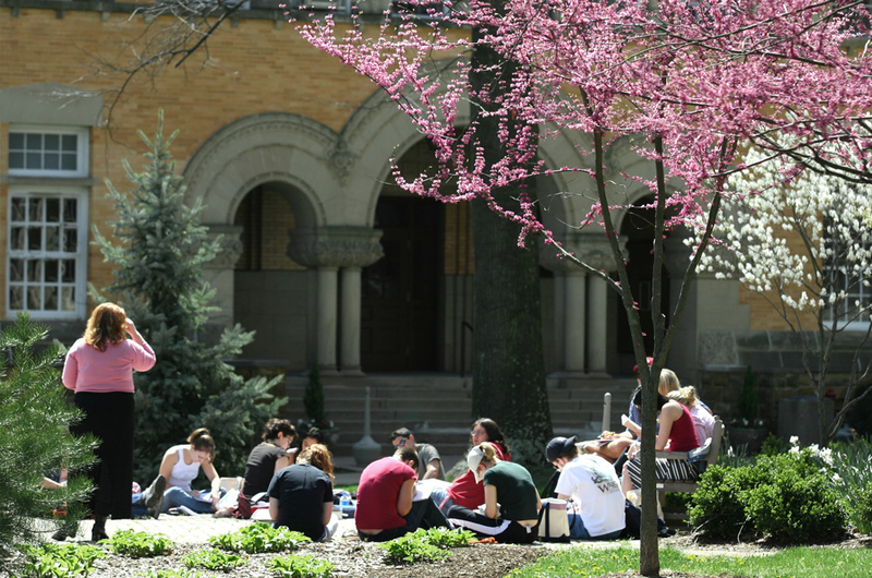 Students sitting on the academic quad in the spring