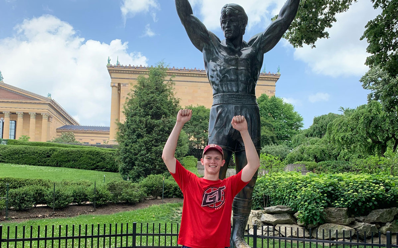 Benny Mandelbrot in Philadelphia posing in front of statue