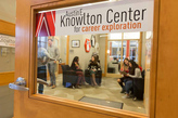 Door of the Knowlton center looking in at students