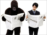 Gorilla and man reading newspapers