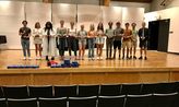 Students with awards on stage