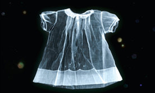 Photo of a child size dress against a black background