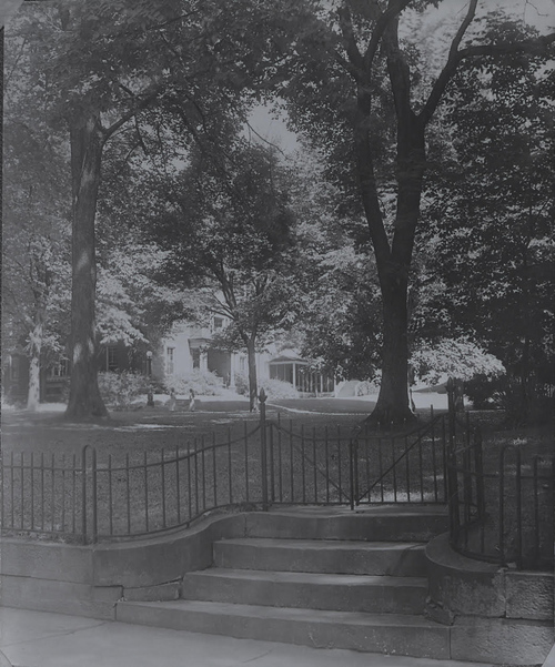 Shepardson's old iron fence, which was torn down during World War II, is shown here next to the stone steps from Broadway that are still there. King Hall is in the background.