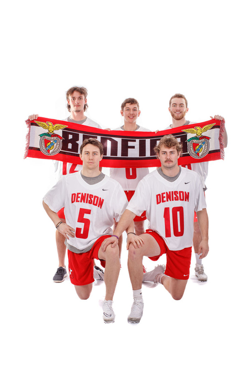 Members of the men’s lacrosse team spent the 2022 fall semester in Lisbon, Portugal. They hold a supporters scarf for the Lisbon-based soccer club S.L. Benfica. (Credit: Jace Delgado)